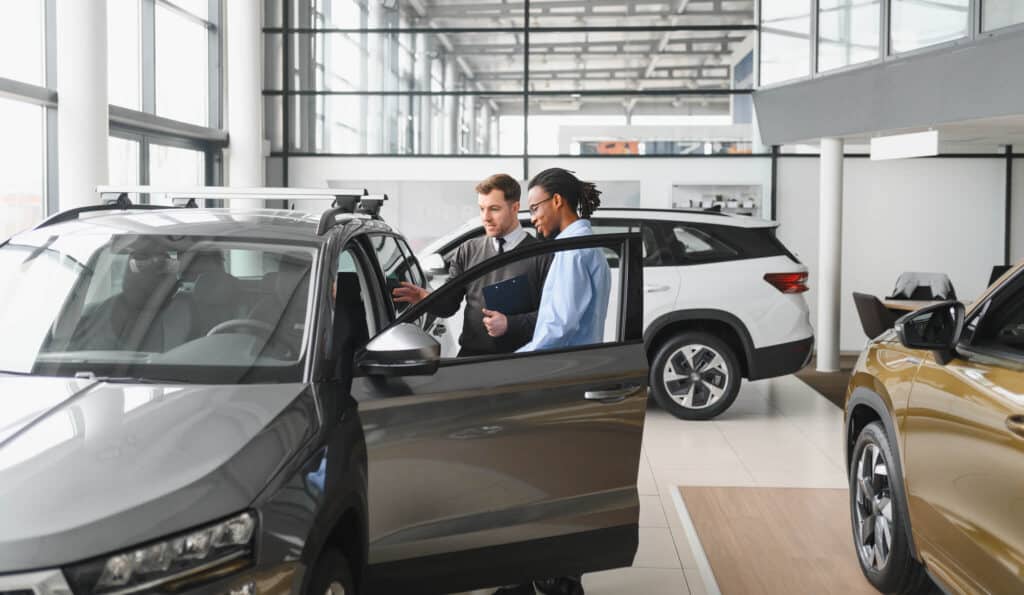Car Dealer Showing Customer Car