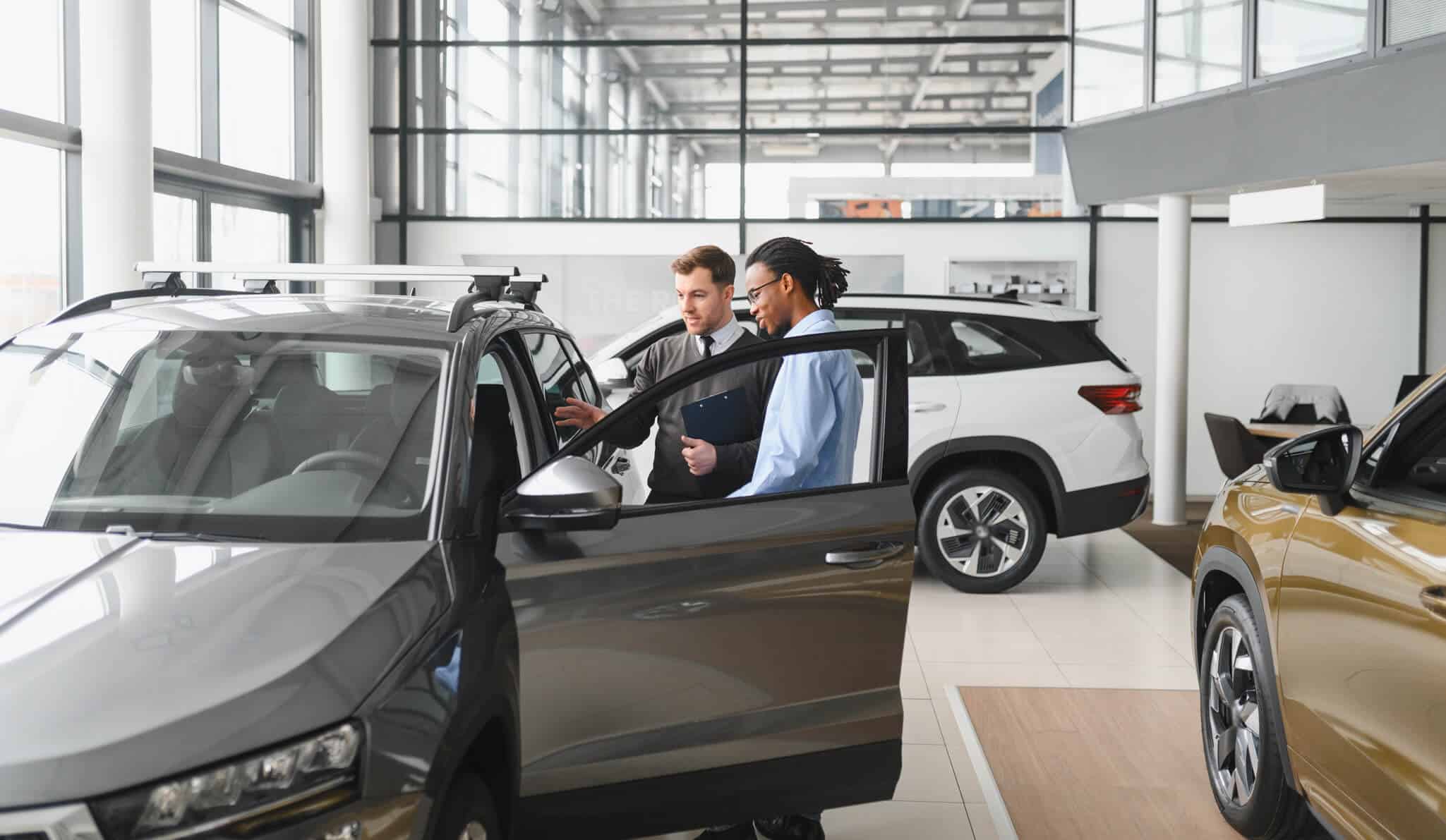 Car Dealer Showing Customer Car