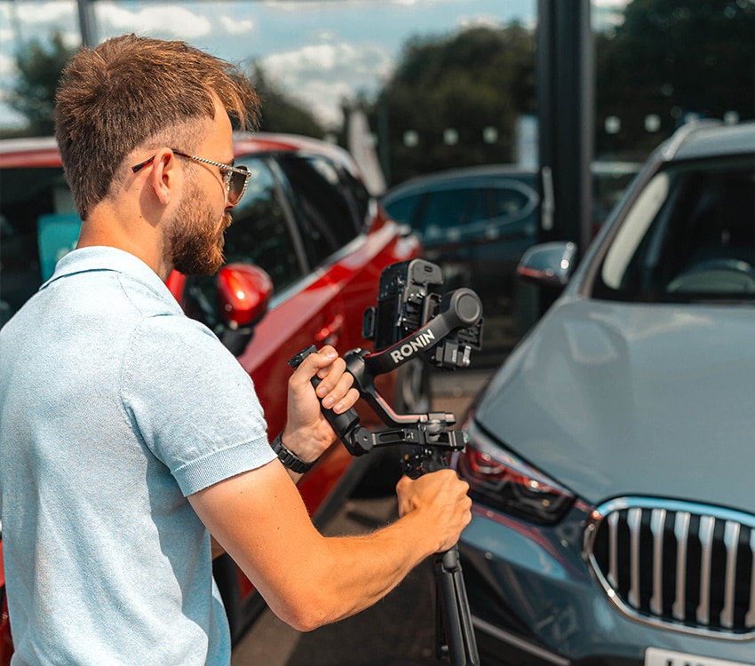 Man shooting video content of cars